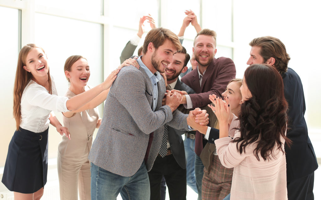 A business team applauding their successful project leader